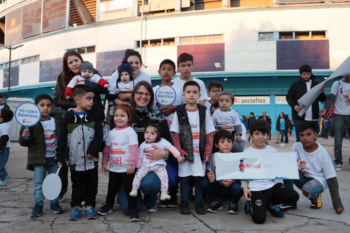 Silvia smiling with many patients