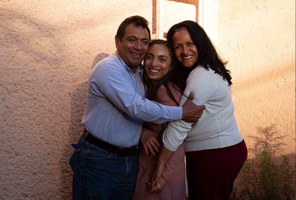 Adahara now, after cleft treatment, with her parents