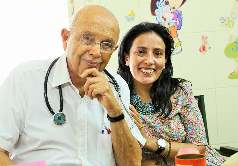 Dr. Adenwalla smiling with Mamta Carroll