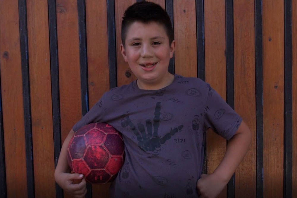 Amaro smiling with a soccer ball