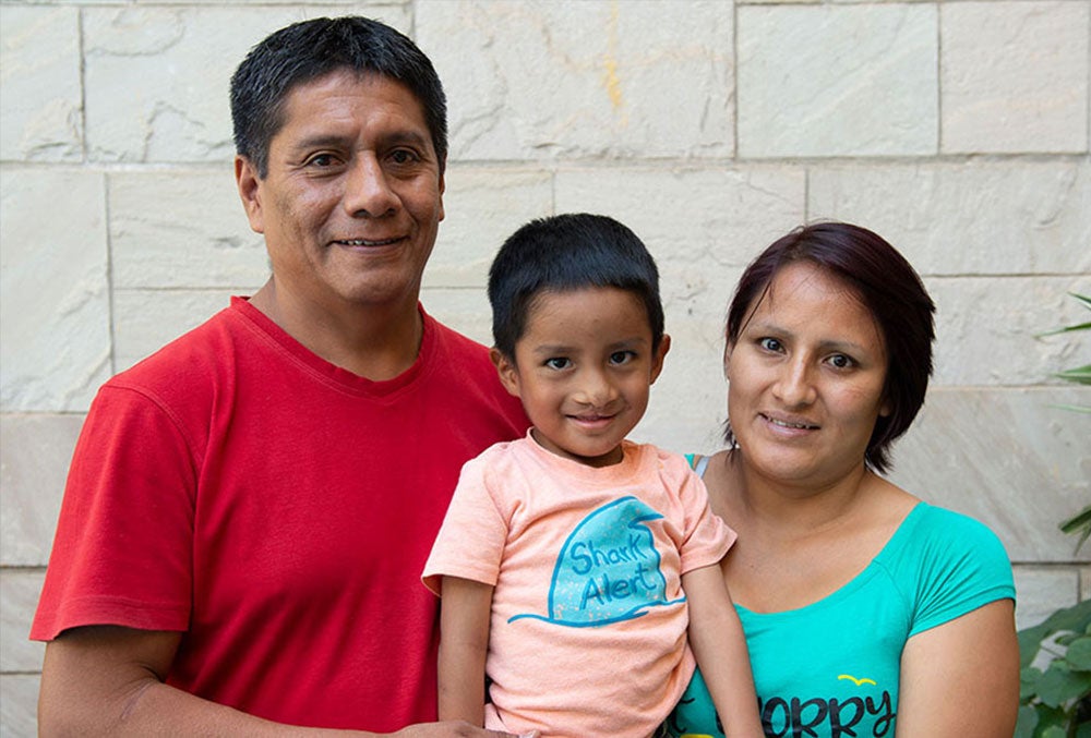 Anghelo smiling with his parents