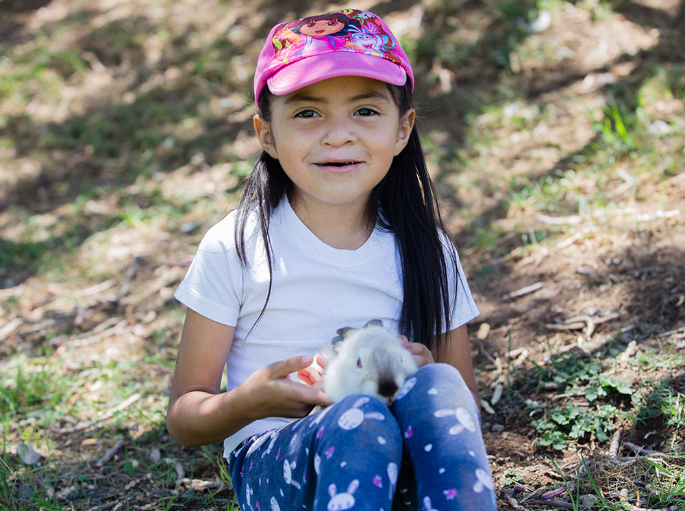 Barbara with her pet rabbit after Smile Train-sponsored cleft surgery