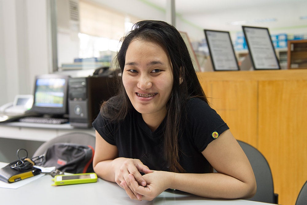 Gracee smiling at desk