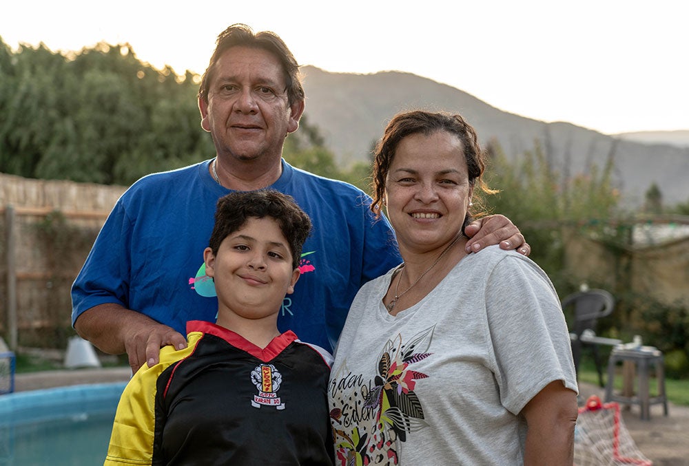 Juan smiling with his parents