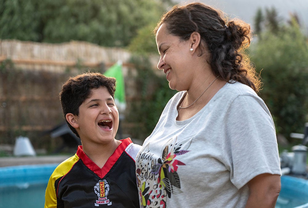 Juan with his mother laughing and hugging