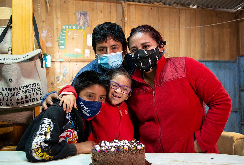 Kristhell celebrating her birthday with her brother, father, and mother