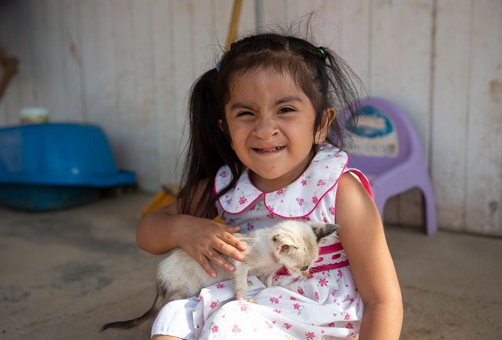 Kristhell holding her kitten. Photo taken in 2019.