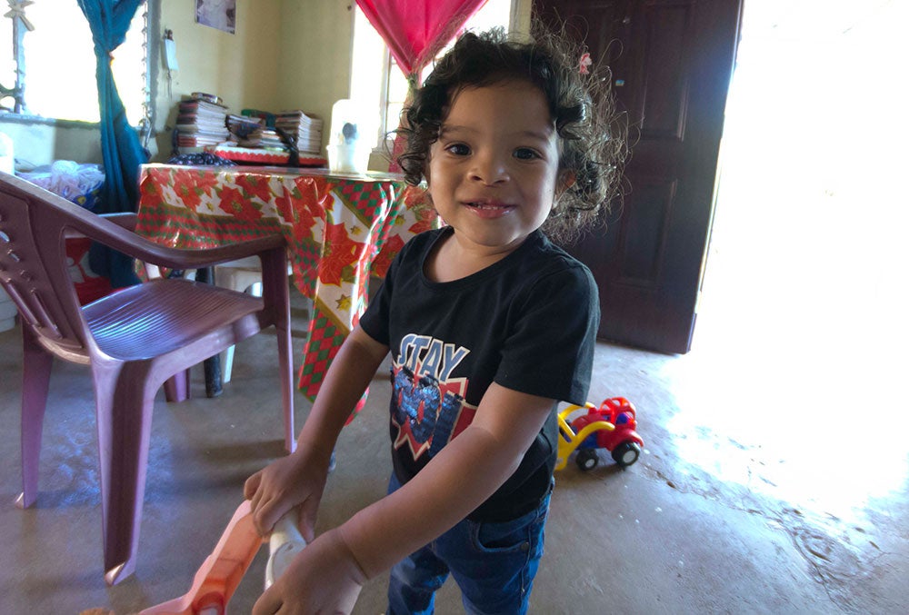 Marco playing with a toy shopping cart