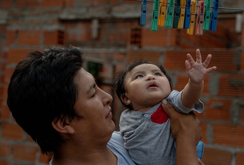 Miguel reaches for clothespins