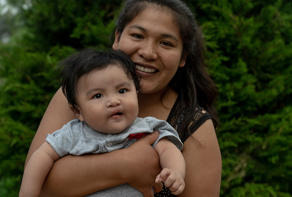Zulema holding Miguel after cleft surgery