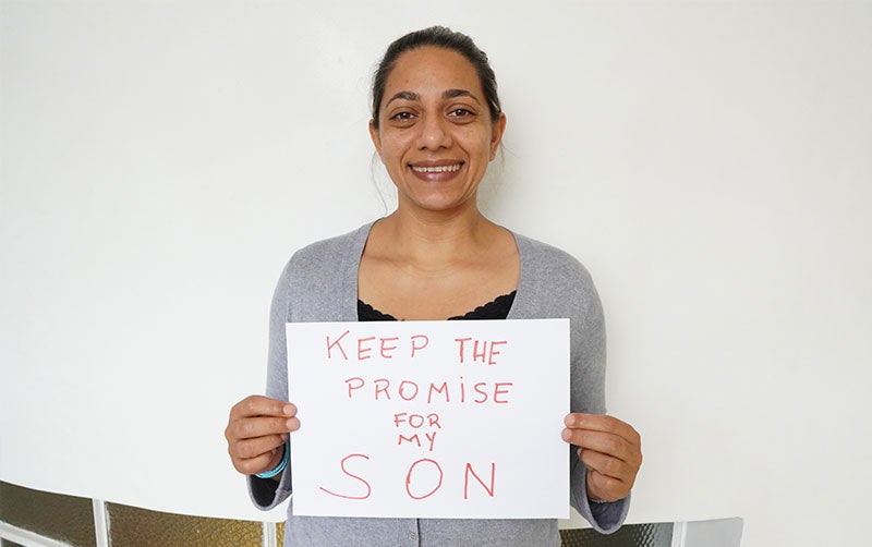 Mom holding sign keep the promise for my son