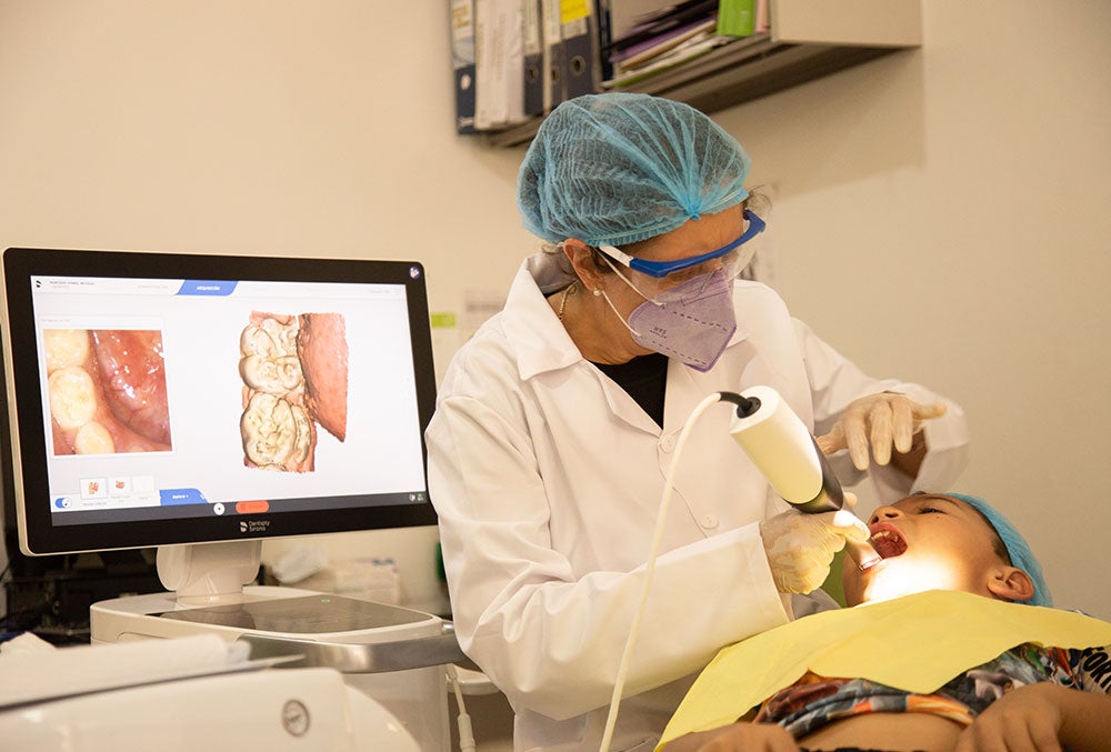 A technician at FISULAB uses the Primescan AC