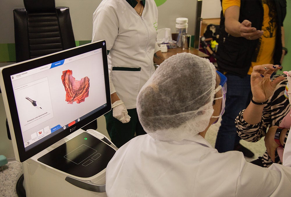 A technician at FISULAB using Dentsply Sirona's Primescan AC