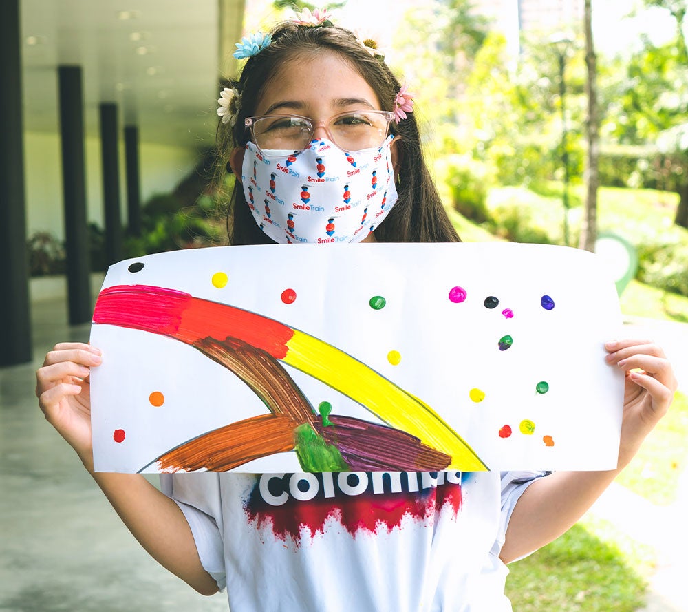 Valery holding a mandala she made at the Life Project