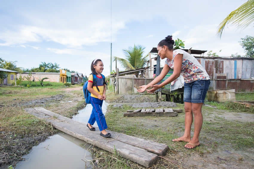 Victoria crossing a plank over a creek into Veronilee's arms