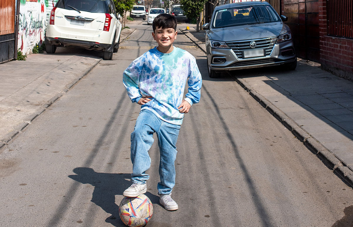 Joaquin posing with his foot on a soccer ball