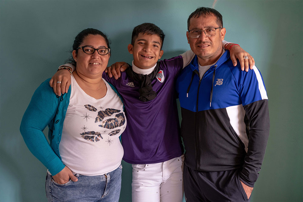 Bautista smiling with his parents Soledad and Luis