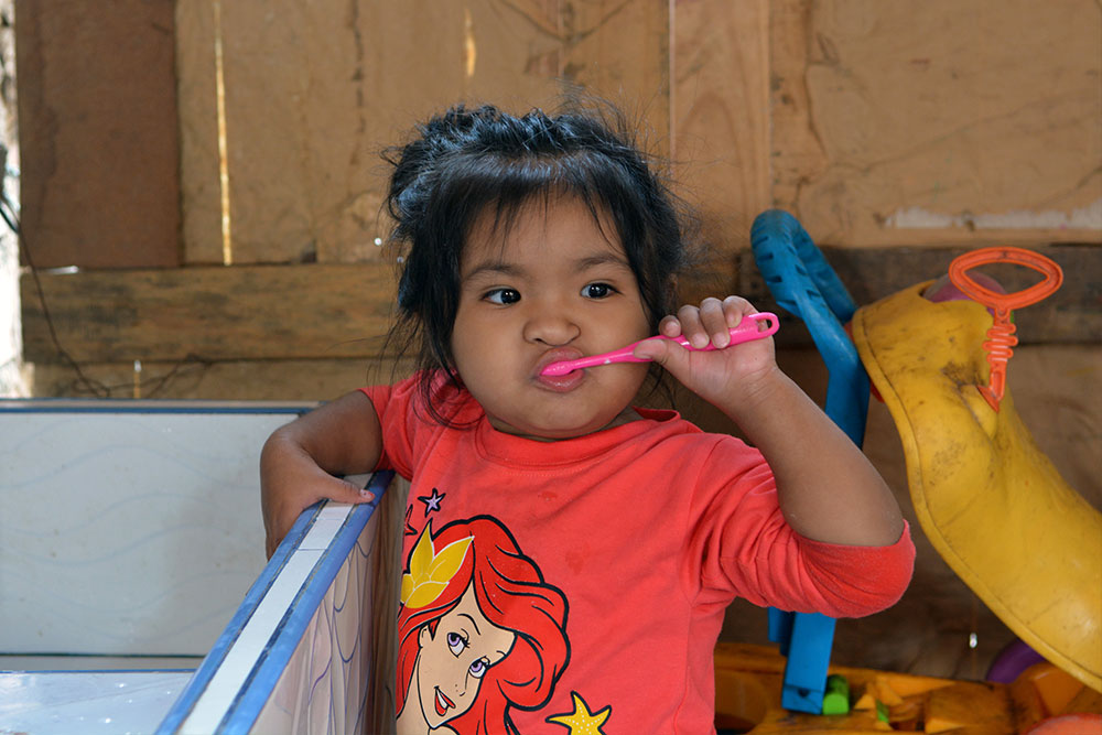 Shaymi brushing her teeth after cleft surgery