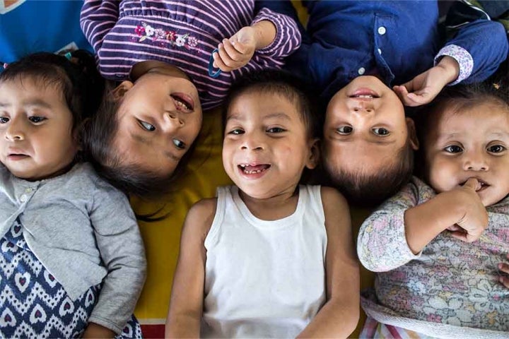 Auner smiling and lying down with his friends