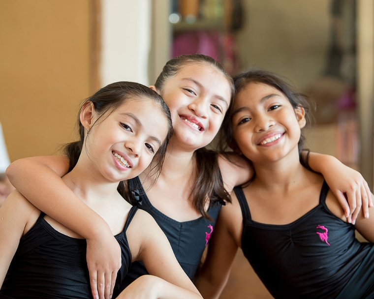 Aquetzaly smiling with her ballet classmates