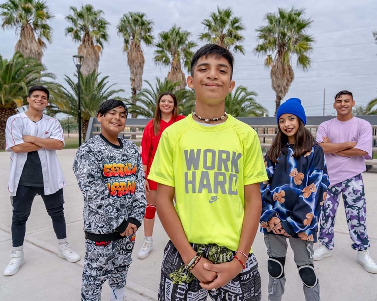 Bautista smiling and standing with his dance crew