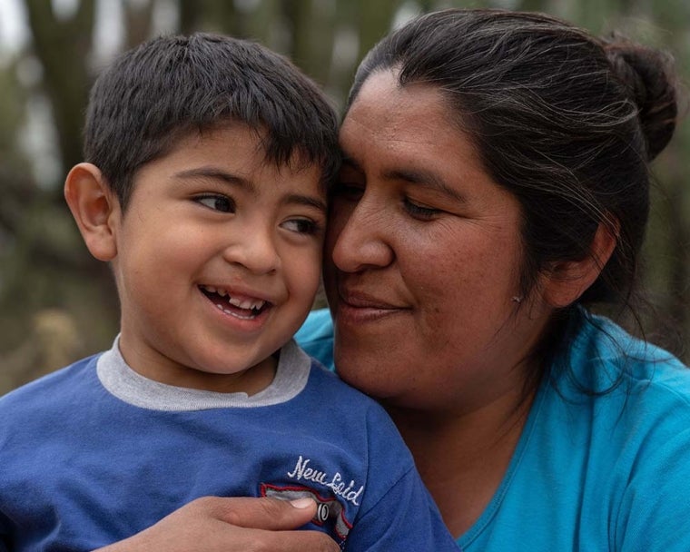 Walter smiles as Valeria hugs and holds him cheek-to-cheek